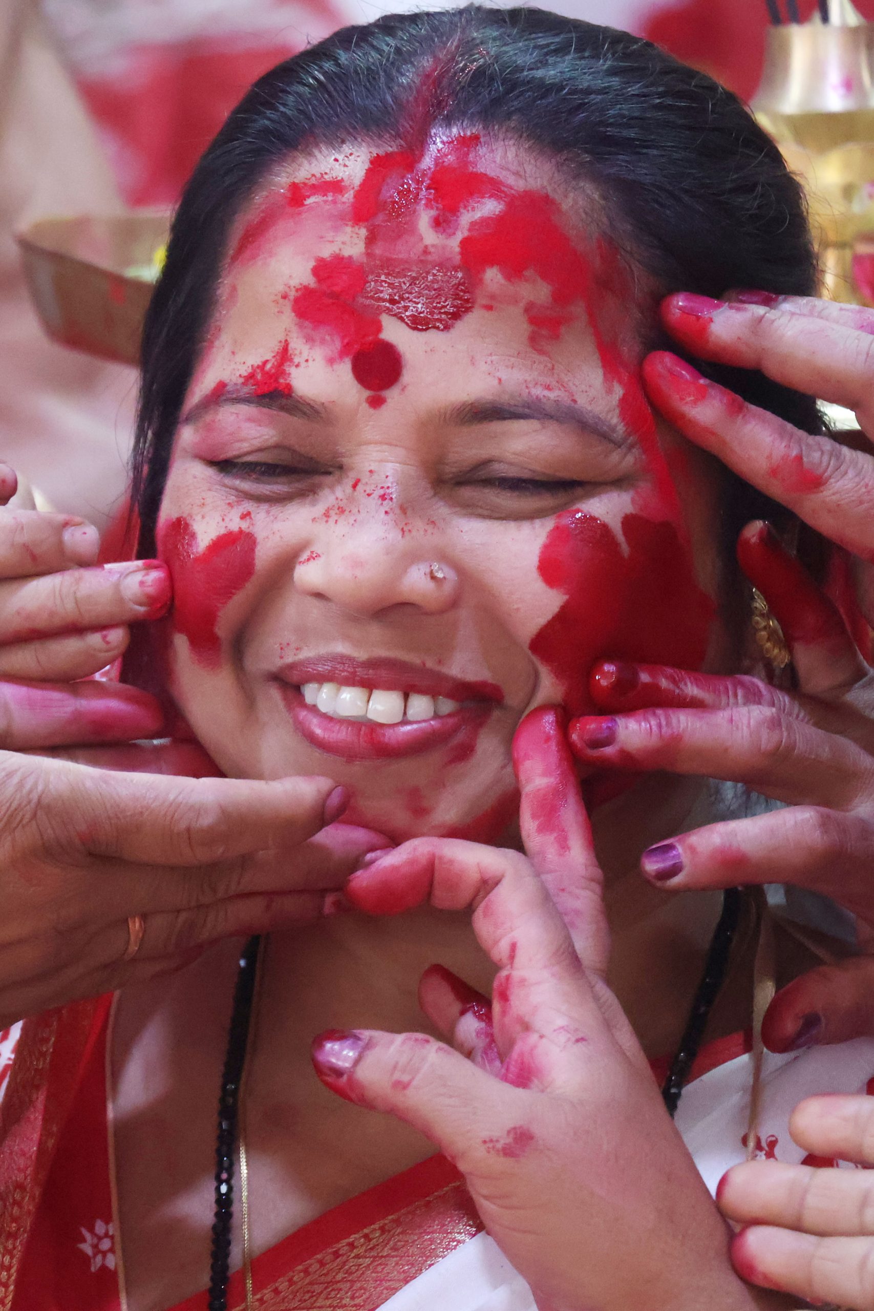 Women enjoy playing vermilion on Vijaya Dashami of Basanti Puja.